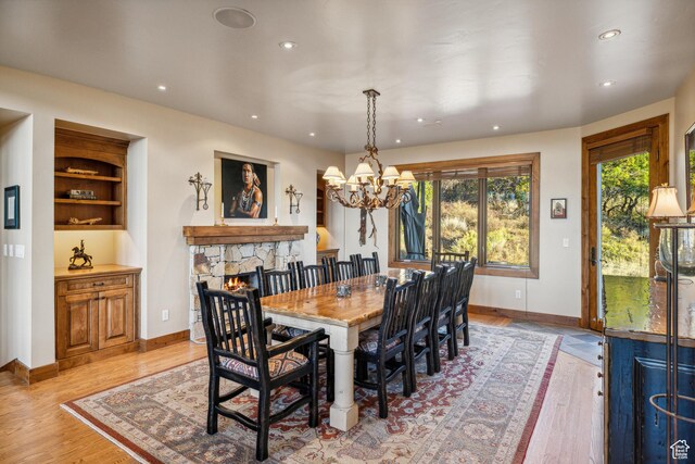 75 Hidden Oaks Ln, Park City, UT 84060 - dining space with light wood-style flooring, a chandelier, baseboards, recessed lighting, and a stone fireplace