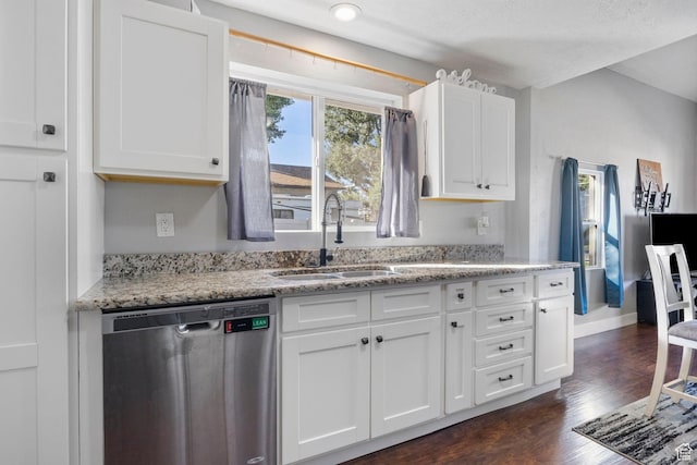 kitchen featuring dark wood-style flooring, stainless steel dishwasher, white cabinets, and a sink