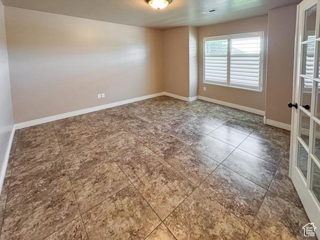 spare room with baseboards