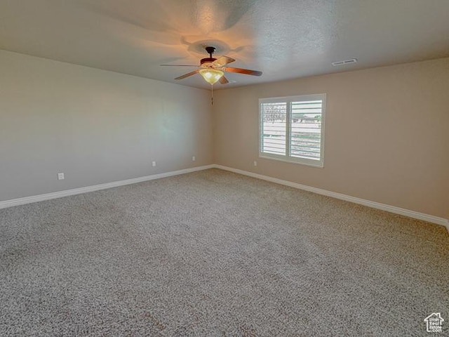 spare room featuring baseboards, a ceiling fan, and carpet floors