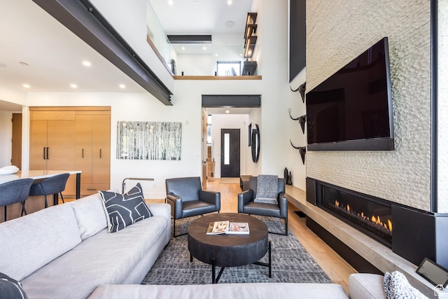 3576 Ridgeline Dr Unit 14-C, Park City, UT 84098 - living room with wood finished floors, a glass covered fireplace, a towering ceiling, and recessed lighting