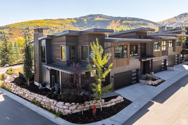 3576 Ridgeline Dr Unit 14-C, Park City, UT 84098 - view of front of property with a garage, a mountain view, driveway, and a chimney