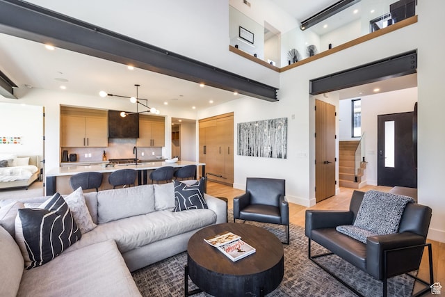3576 Ridgeline Dr Unit 14-C, Park City, UT 84098 - living area with recessed lighting, baseboards, light wood-style flooring, and a towering ceiling