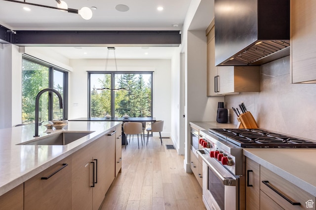 3576 Ridgeline Dr Unit 14-C, Park City, UT 84098 - kitchen with stainless steel stove, a sink, wall chimney range hood, plenty of natural light, and recessed lighting