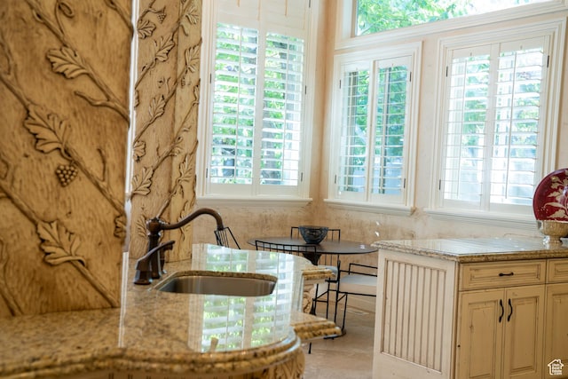 kitchen with light stone counters and a sink