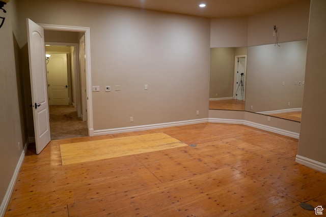 unfurnished room with baseboards and recessed lighting