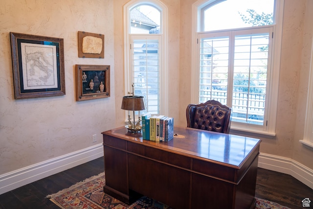 office space with dark wood-style flooring and baseboards