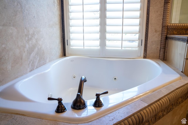 full bath with a whirlpool tub and plenty of natural light