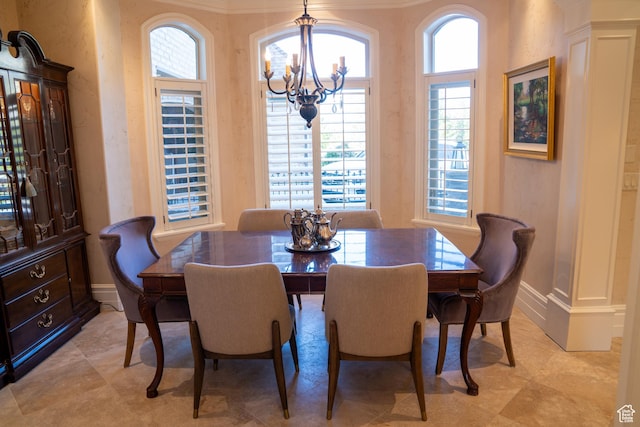 dining room with a wealth of natural light, a notable chandelier, and baseboards