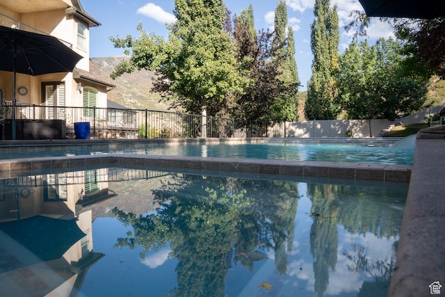 view of swimming pool featuring fence and a fenced in pool