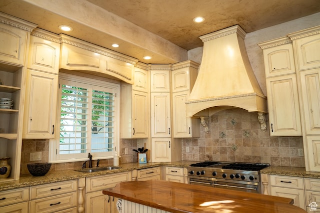kitchen with custom exhaust hood, a sink, wooden counters, double oven range, and recessed lighting