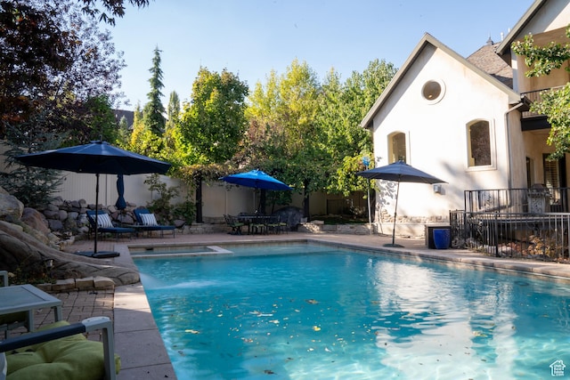 view of pool featuring a patio area, a fenced in pool, and fence