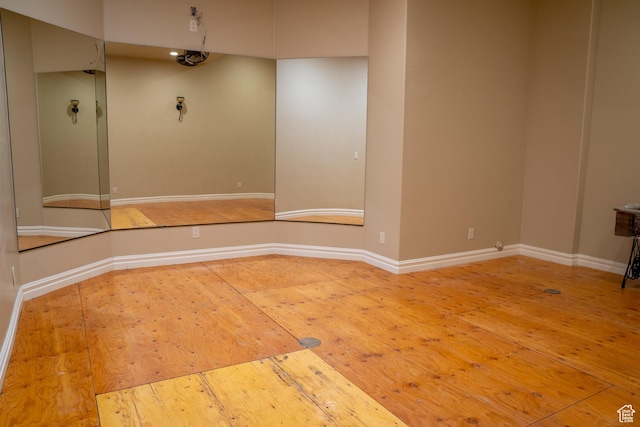 empty room featuring wood-type flooring and baseboards