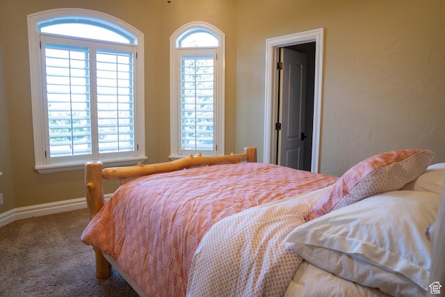 carpeted bedroom with baseboards