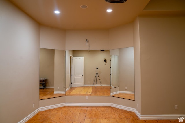 interior space featuring recessed lighting, baseboards, and wood finished floors