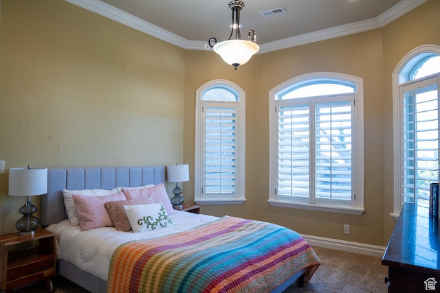 bedroom with carpet, visible vents, multiple windows, and ornamental molding