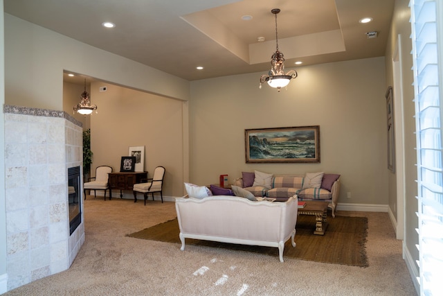 carpeted living room featuring baseboards, a glass covered fireplace, and recessed lighting