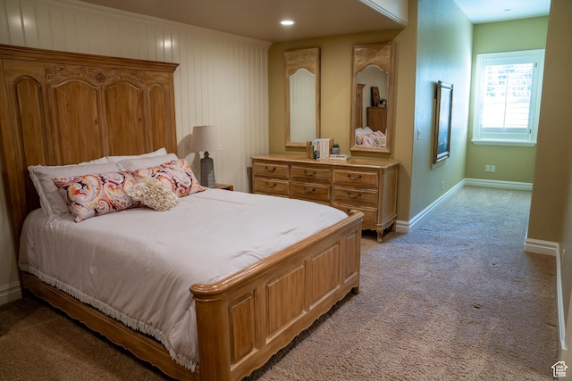 bedroom with light carpet and baseboards