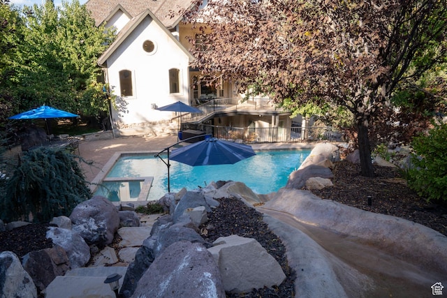 view of pool with a fenced in pool, a patio area, and fence