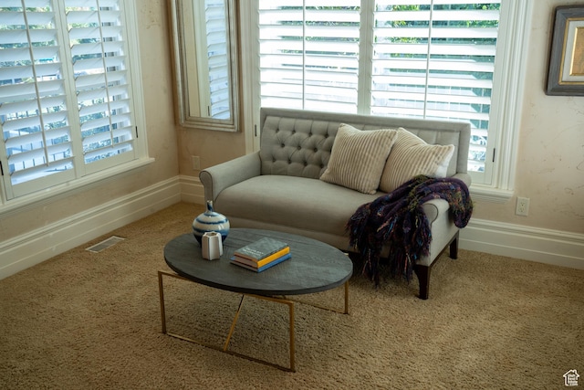 sitting room featuring carpet flooring, baseboards, and visible vents