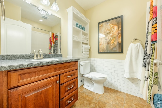 2662 N 1550 W, Pleasant Grove, UT 84062 - full bathroom featuring tile patterned flooring, toilet, vanity, a wainscoted wall, and tile walls