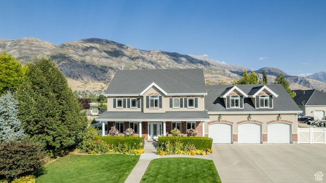 2662 N 1550 W, Pleasant Grove, UT 84062 - view of front facade featuring concrete driveway, a mountain view, covered porch, an attached garage, and stucco siding
