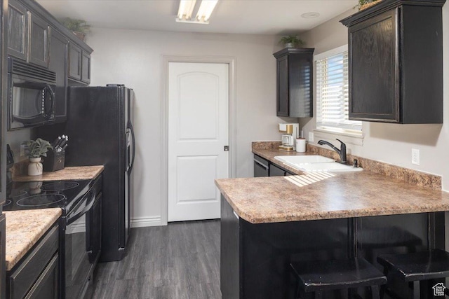 783 W 900 S, Tremonton, UT 84337 - kitchen with light countertops, a peninsula, dark wood-style floors, black appliances, and a sink