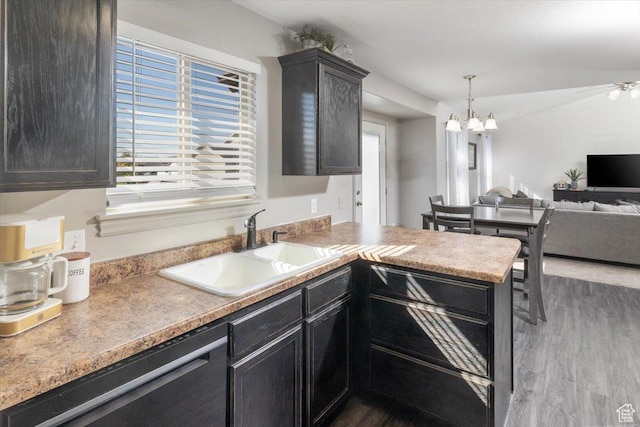 783 W 900 S, Tremonton, UT 84337 - kitchen with dark wood-type flooring, a sink, open floor plan, a peninsula, and dishwashing machine