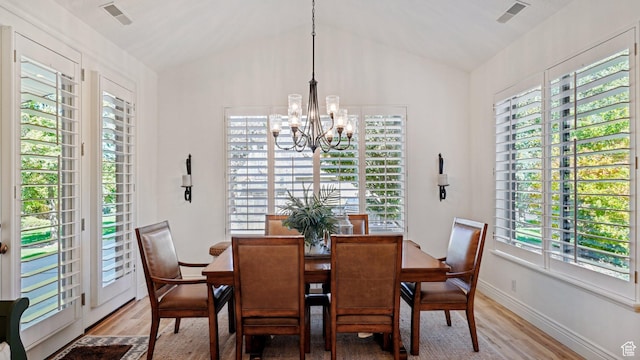 dining space featuring a notable chandelier, light wood-type flooring, and plenty of natural light