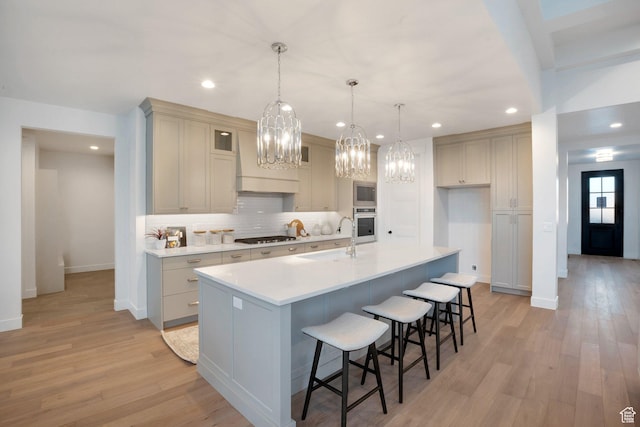 731 W Sara Dr, Saratoga Springs, UT 84045 - kitchen featuring a sink, premium range hood, a chandelier, baseboards, and backsplash