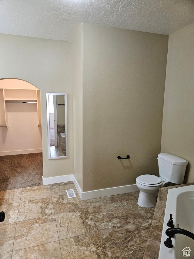 772 S 150 E, Smithfield, UT 84335 - full bath featuring baseboards, toilet, a textured ceiling, and visible vents
