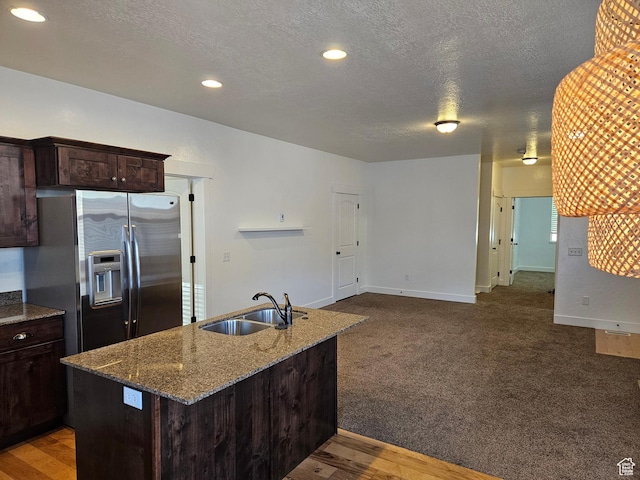 772 S 150 E, Smithfield, UT 84335 - kitchen featuring a sink, dark stone counters, stainless steel fridge, and a textured ceiling