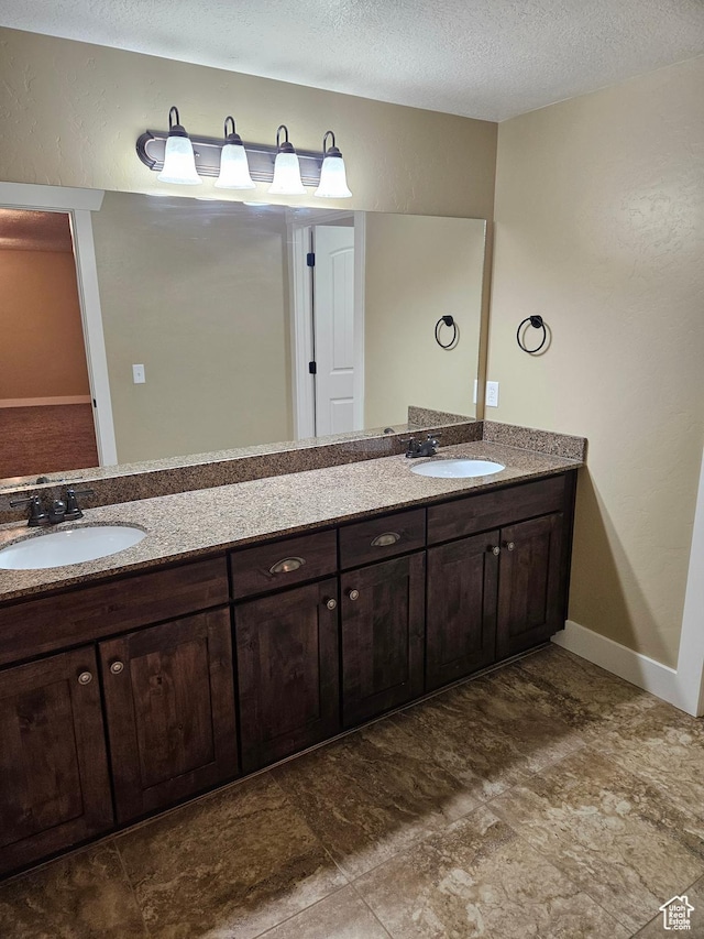 772 S 150 E, Smithfield, UT 84335 - full bath with double vanity, a sink, and a textured ceiling