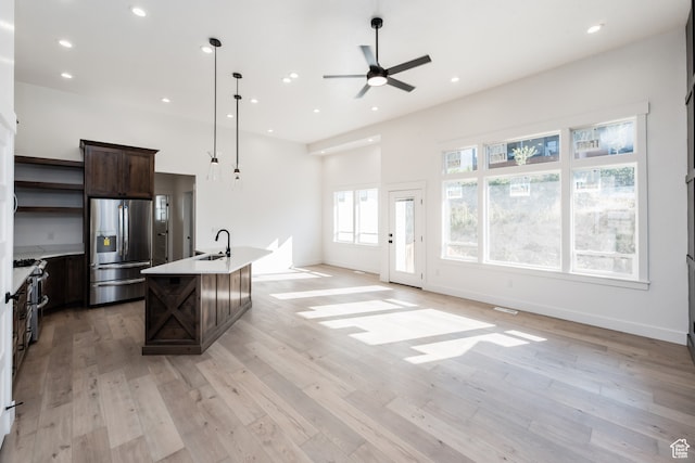 110 S 950 E Unit 45, Hyde Park, UT 84318 - kitchen featuring pendant lighting, a kitchen island with sink, stainless steel appliances, and light wood-type flooring