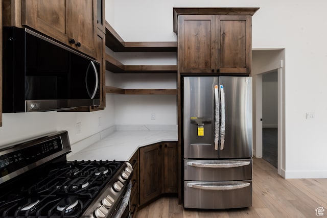110 S 950 E Unit 45, Hyde Park, UT 84318 - kitchen featuring light stone countertops, stainless steel appliances, light hardwood / wood-style floors, and dark brown cabinets