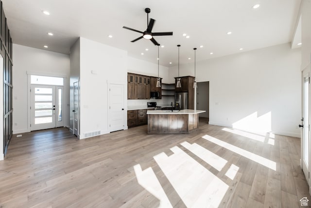 110 S 950 E Unit 45, Hyde Park, UT 84318 - kitchen with a kitchen island, pendant lighting, dark brown cabinets, light hardwood / wood-style flooring, and stainless steel fridge with ice dispenser