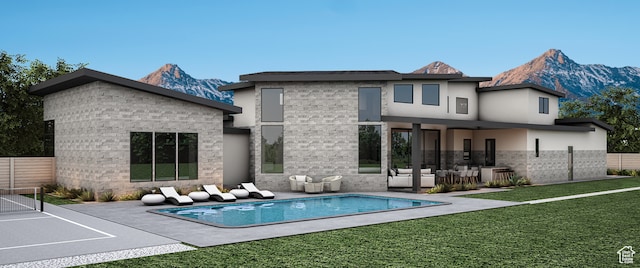 13941 S Jarvie Ln, Draper, UT 84020 - rear view of house with a lawn, a mountain view, a patio area, and a fenced in pool