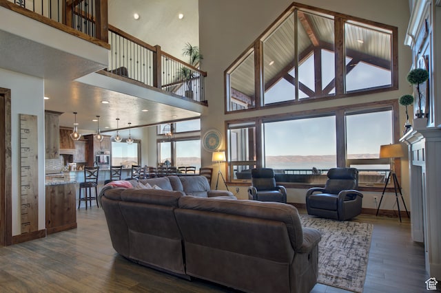 86 Aster Pl, Fish Haven, ID 83287 - living room with an inviting chandelier, dark hardwood / wood-style flooring, and high vaulted ceiling