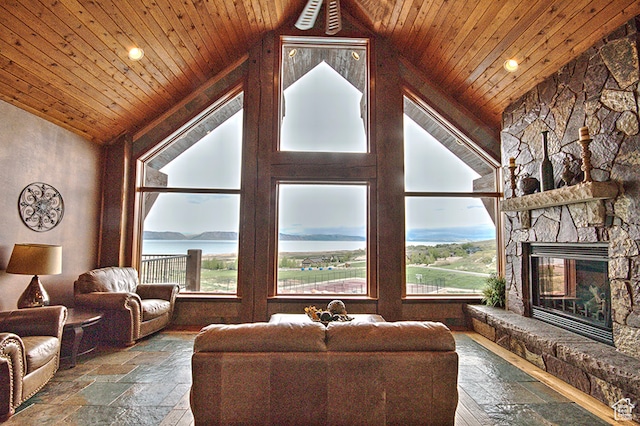 86 Aster Pl, Fish Haven, ID 83287 - living room featuring a stone fireplace, plenty of natural light, a water view, and wooden ceiling