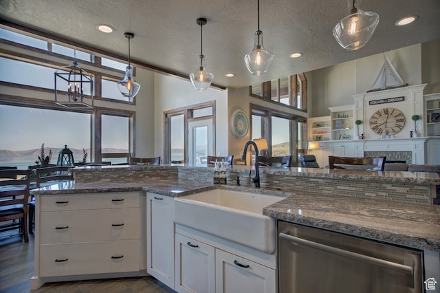 86 Aster Pl, Fish Haven, ID 83287 - kitchen with pendant lighting, a textured ceiling, sink, white cabinets, and stainless steel dishwasher