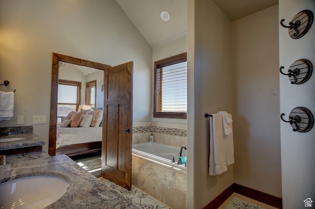 86 Aster Pl, Fish Haven, ID 83287 - bathroom featuring vanity, lofted ceiling, tiled bath, and a healthy amount of sunlight