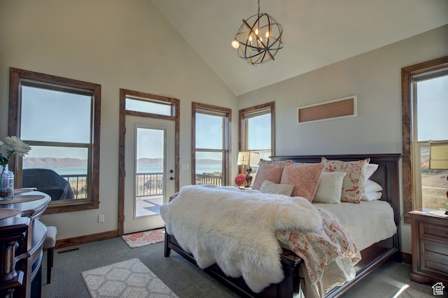 86 Aster Pl, Fish Haven, ID 83287 - carpeted bedroom with a notable chandelier, a water view, high vaulted ceiling, and access to exterior