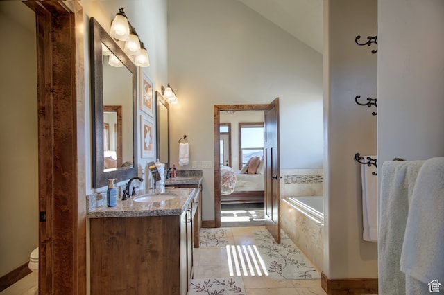 86 Aster Pl, Fish Haven, ID 83287 - bathroom with a relaxing tiled tub, vanity, toilet, and tile patterned floors