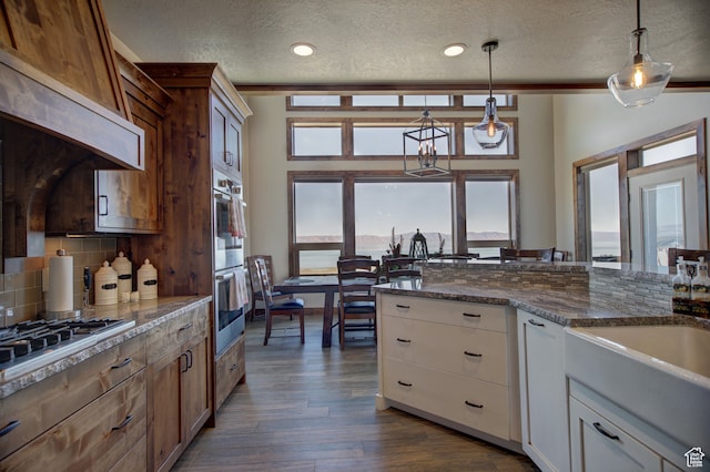86 Aster Pl, Fish Haven, ID 83287 - kitchen with a wealth of natural light, white cabinetry, a textured ceiling, and decorative light fixtures
