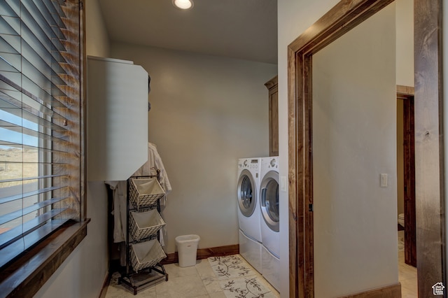 86 Aster Pl, Fish Haven, ID 83287 - laundry room featuring cabinets, washing machine and dryer, and light tile patterned flooring