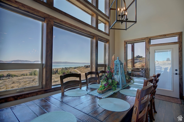 86 Aster Pl, Fish Haven, ID 83287 - dining area with an inviting chandelier, a high ceiling, and hardwood / wood-style floors