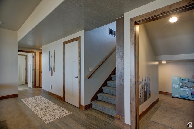86 Aster Pl, Fish Haven, ID 83287 - stairs with hardwood / wood-style flooring, vaulted ceiling, and a textured ceiling