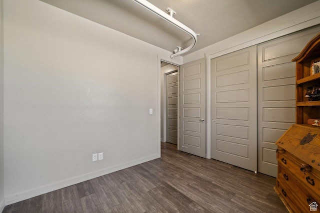 665 S 1400 W, Syracuse, UT 84075 - unfurnished bedroom with a closet, baseboards, and dark wood-style floors