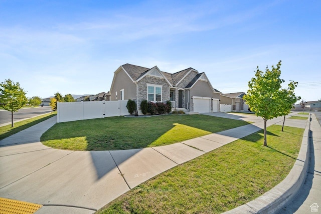665 S 1400 W, Syracuse, UT 84075 - view of front of home featuring driveway, stone siding, an attached garage, a front yard, and fence