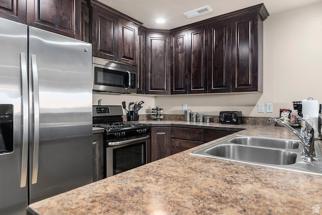3862 Desert Willow Cir Unit A8, Moab, UT 84532 - kitchen featuring dark brown cabinets, stainless steel appliances, and sink